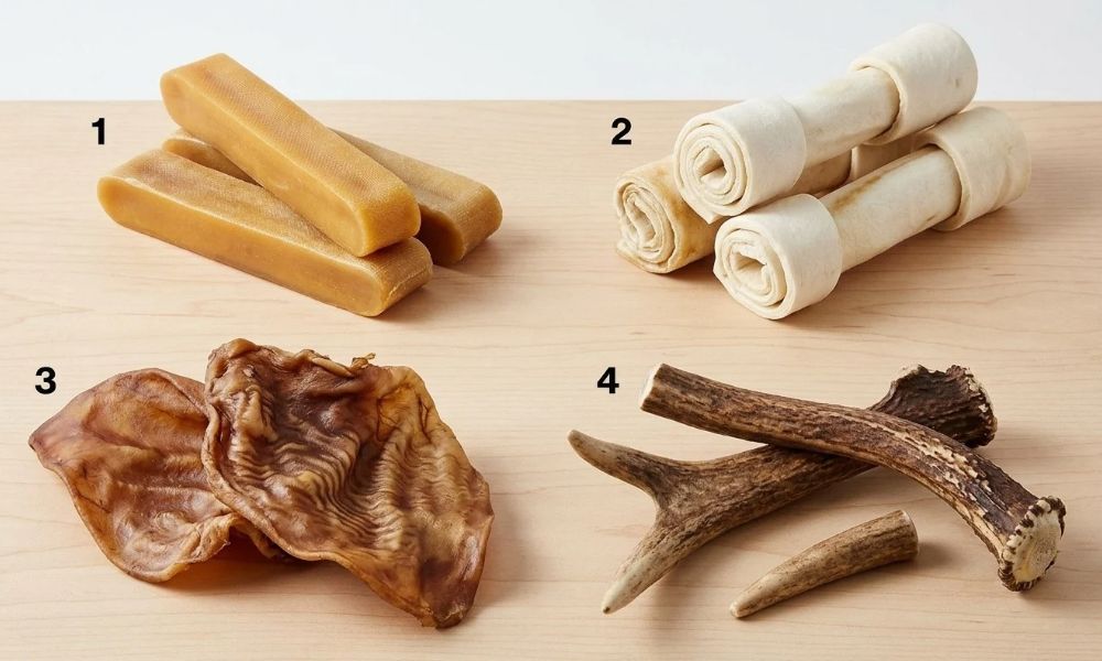 Natural dog treats including yak cheese chews, cattle rawhide, dried pig ears, and antlers.